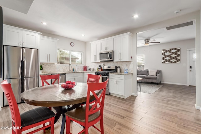 kitchen featuring appliances with stainless steel finishes, white cabinetry, and plenty of natural light