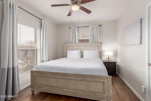 bedroom featuring a ceiling fan, baseboards, and wood finished floors