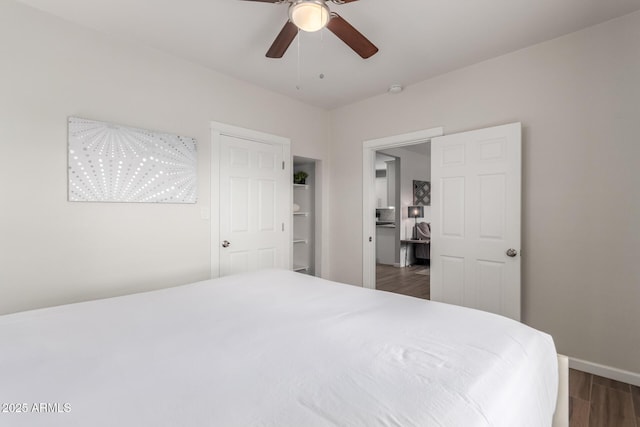 bedroom featuring a ceiling fan, baseboards, and dark wood-type flooring