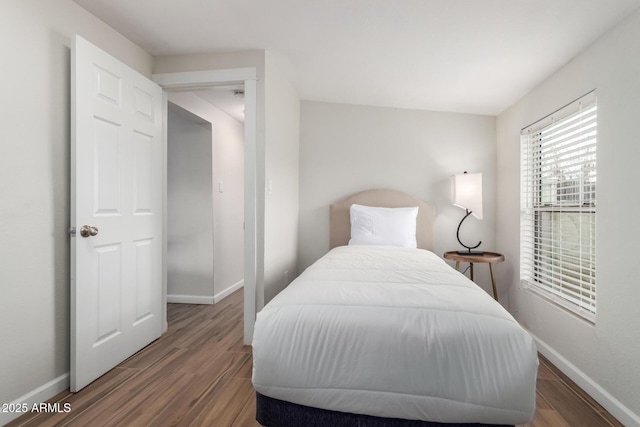 bedroom with wood finished floors and baseboards