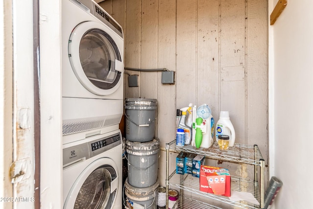 laundry room featuring laundry area and stacked washer / drying machine