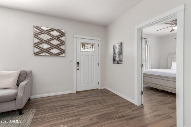 entrance foyer featuring a ceiling fan, baseboards, and wood finished floors