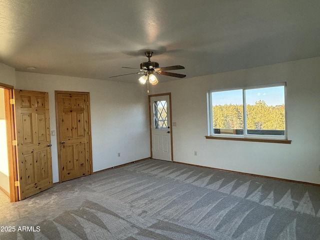 carpeted empty room with ceiling fan