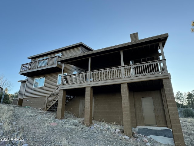 back of property with a balcony