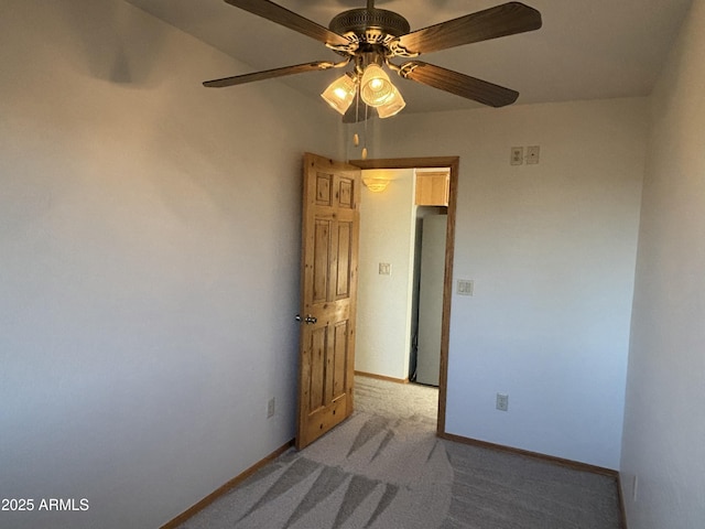 empty room with light colored carpet and ceiling fan