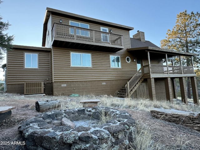 rear view of house featuring cooling unit