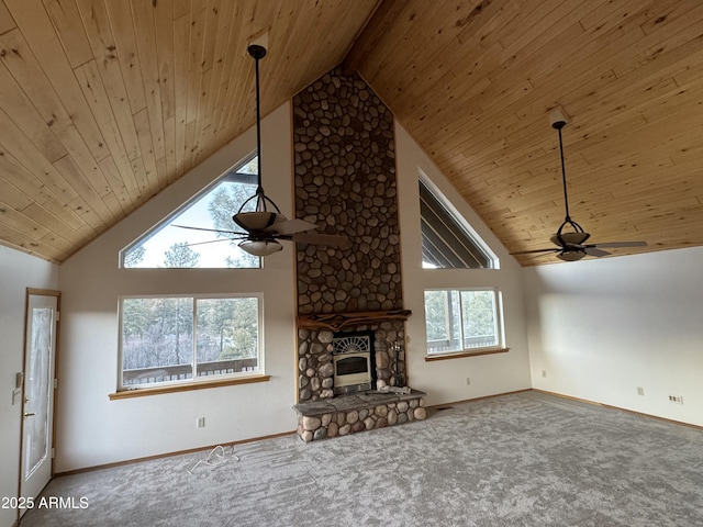 unfurnished living room featuring ceiling fan, wooden ceiling, high vaulted ceiling, and a stone fireplace