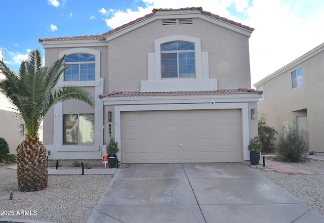 mediterranean / spanish house featuring a garage