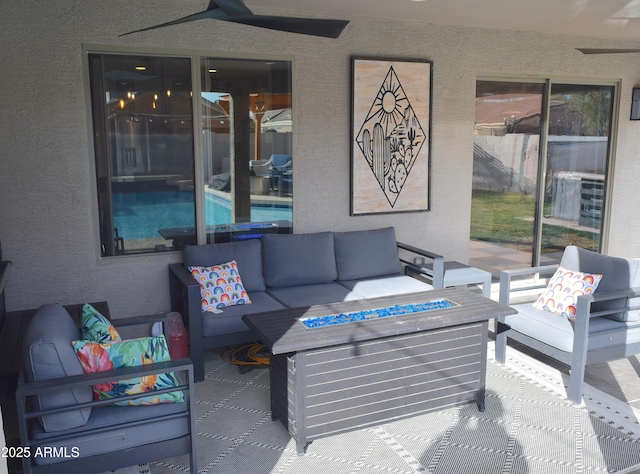 view of patio with an outdoor living space with a fire pit