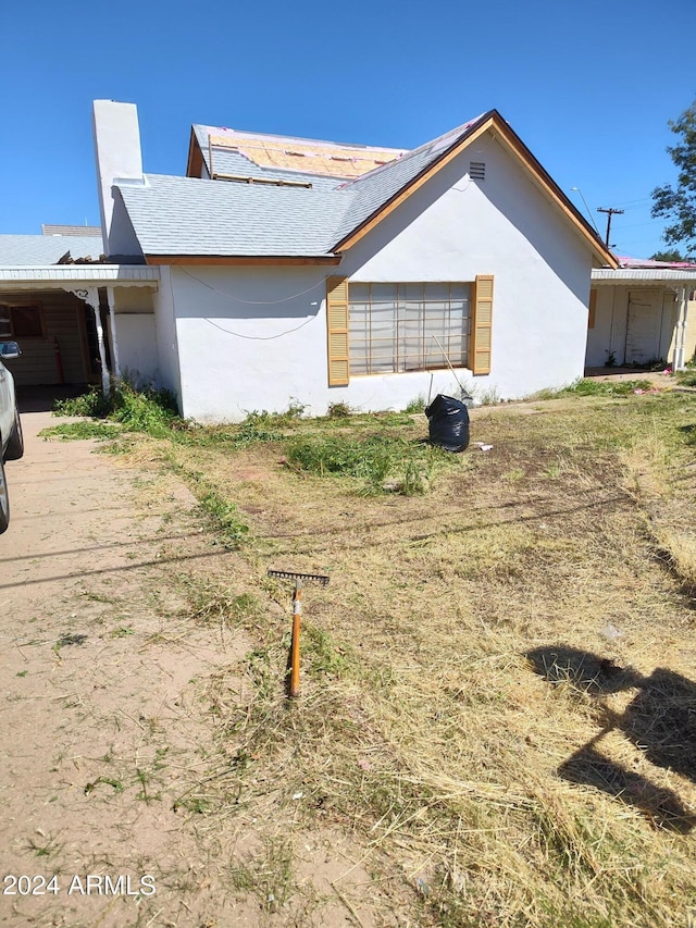 view of property exterior featuring a carport