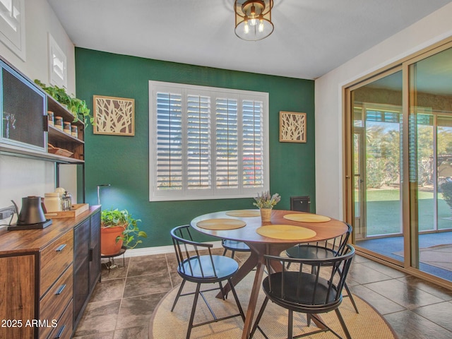 dining area with dark tile patterned floors