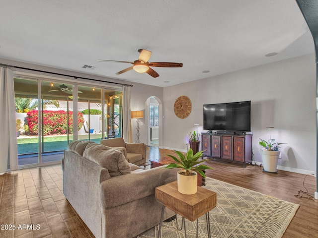 living room with hardwood / wood-style floors and ceiling fan