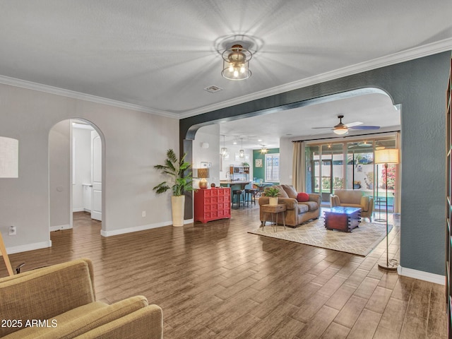 living room featuring hardwood / wood-style flooring, ceiling fan, and ornamental molding