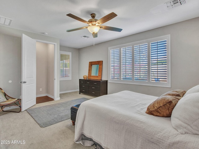 bedroom featuring light colored carpet and ceiling fan