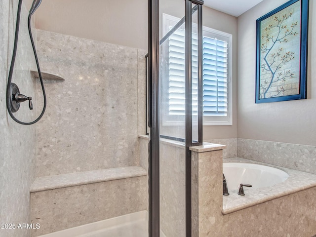 bathroom featuring independent shower and bath