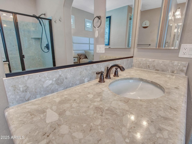 bathroom with vanity and a shower with shower door