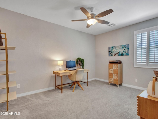 office space with light carpet and ceiling fan