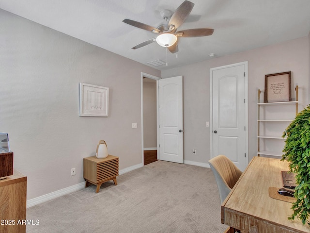 office space with light colored carpet and ceiling fan