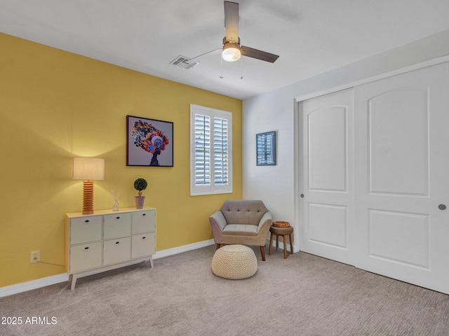 sitting room with light colored carpet and ceiling fan