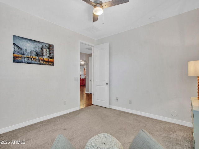 unfurnished room featuring ceiling fan and light colored carpet