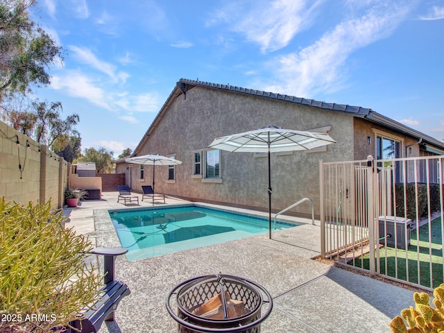 view of pool featuring a fire pit, central AC, and a patio