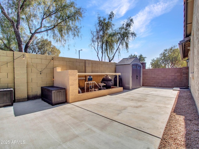 view of patio featuring a shed