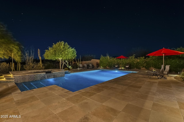 8248 E Arroyo Hondo Rd, Scottsdale, AZ 85266 - pool at night featuring a patio and a pool with connected hot tub