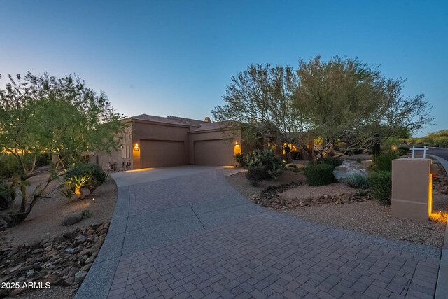 8248 E Arroyo Hondo Rd, Scottsdale, AZ 85266 - view of front of home featuring an attached garage, decorative driveway, and stucco siding