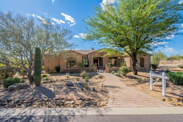 8248 E Arroyo Hondo Rd, Scottsdale, AZ 85266 - pueblo-style house with stucco siding and a gate