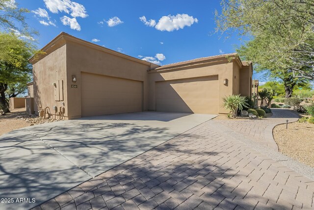 8248 E Arroyo Hondo Rd, Scottsdale, AZ 85266 - view of front of property with stucco siding, a garage, and driveway