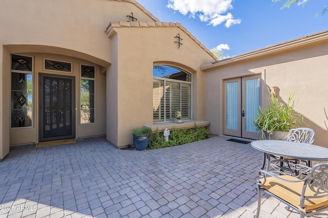 8248 E Arroyo Hondo Rd, Scottsdale, AZ 85266 - entrance to property featuring french doors, a patio area, and stucco siding