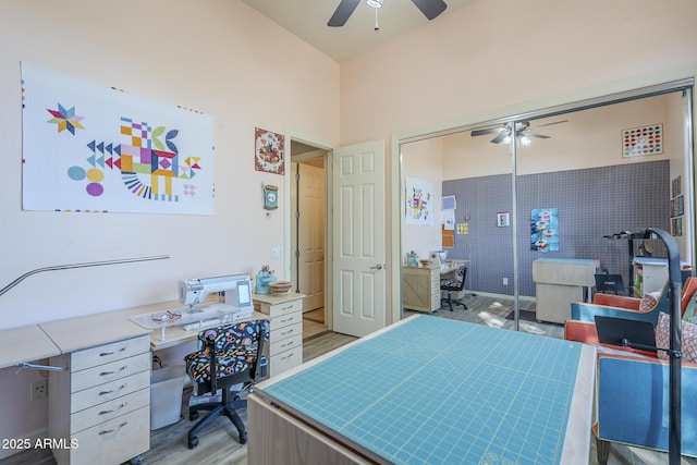 8248 E Arroyo Hondo Rd, Scottsdale, AZ 85266 - bedroom with an office area, light wood-type flooring, a ceiling fan, and a closet