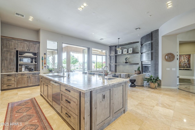 8248 E Arroyo Hondo Rd, Scottsdale, AZ 85266 - kitchen featuring a sink, a fireplace, a center island with sink, dishwasher, and recessed lighting