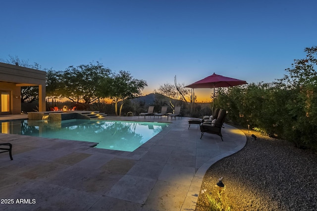 8248 E Arroyo Hondo Rd, Scottsdale, AZ 85266 - pool at dusk with a patio