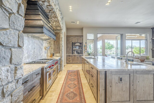 8248 E Arroyo Hondo Rd, Scottsdale, AZ 85266 - kitchen with a sink, appliances with stainless steel finishes, a large island with sink, and decorative backsplash