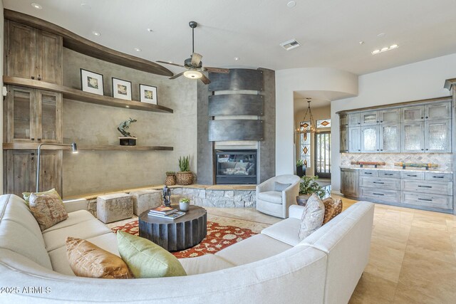 8248 E Arroyo Hondo Rd, Scottsdale, AZ 85266 - living room featuring a large fireplace, ceiling fan, recessed lighting, and light tile patterned floors