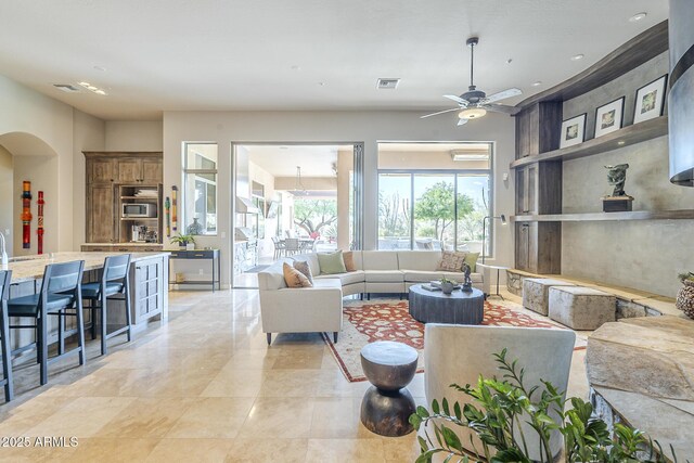 8248 E Arroyo Hondo Rd, Scottsdale, AZ 85266 - living room featuring arched walkways and ceiling fan