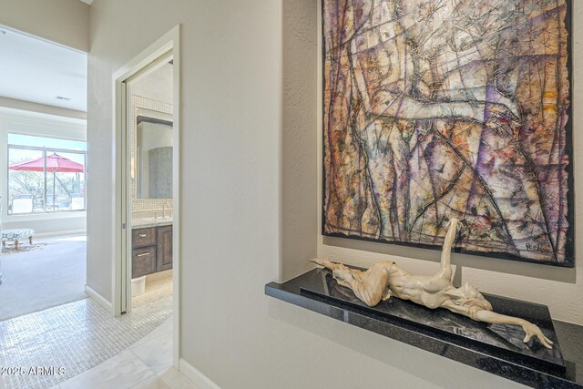 8248 E Arroyo Hondo Rd, Scottsdale, AZ 85266 - hall featuring a sink, carpet flooring, baseboards, and tile patterned flooring
