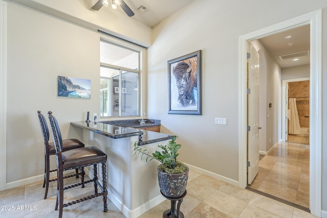 8248 E Arroyo Hondo Rd, Scottsdale, AZ 85266 - bar area featuring ceiling fan, baseboards, and light tile patterned floors