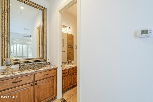8248 E Arroyo Hondo Rd, Scottsdale, AZ 85266 - full bath with two vanities, ceiling fan, and tile patterned floors