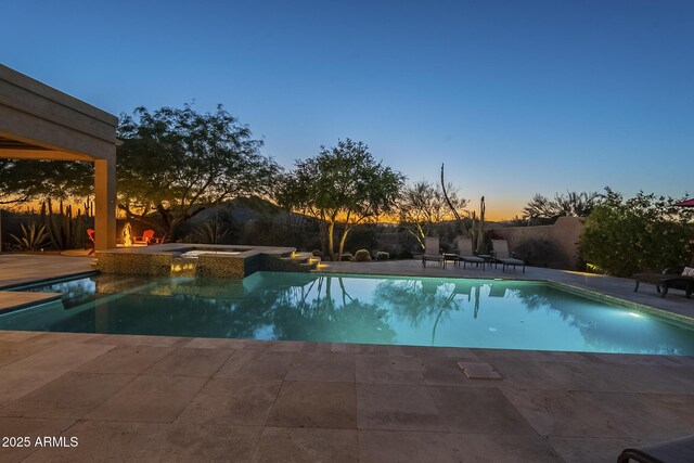 8248 E Arroyo Hondo Rd, Scottsdale, AZ 85266 - pool at dusk with a patio area, fence, and a pool with connected hot tub