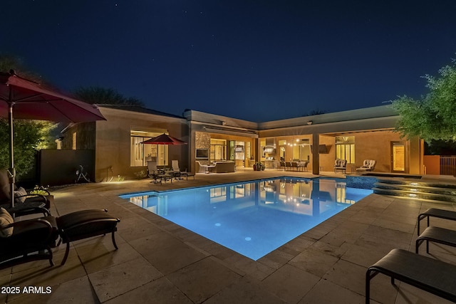 8248 E Arroyo Hondo Rd, Scottsdale, AZ 85266 - pool at twilight featuring a patio and an outdoor pool
