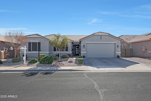 ranch-style home featuring an attached garage, driveway, a tile roof, and stucco siding