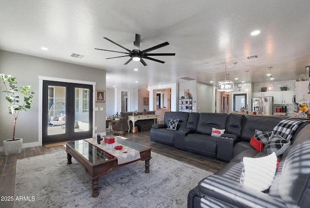 living room with recessed lighting, visible vents, wood finished floors, and french doors