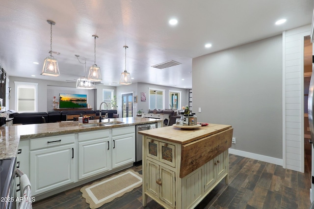 kitchen with dark wood-style flooring, visible vents, open floor plan, a sink, and dishwasher