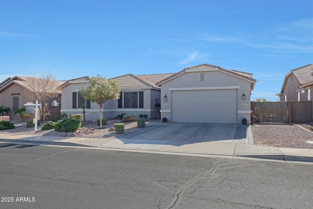 single story home with an attached garage, fence, a tile roof, driveway, and stucco siding