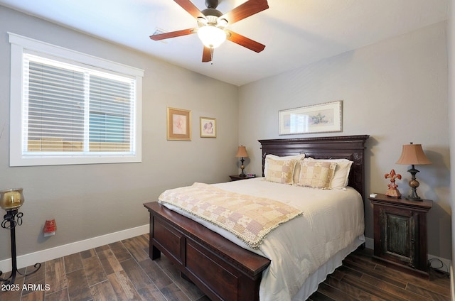 bedroom with ceiling fan, dark wood finished floors, and baseboards