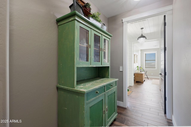 hall featuring dark wood finished floors and baseboards