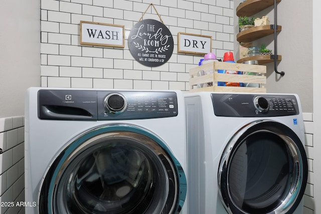 clothes washing area with laundry area and washing machine and clothes dryer