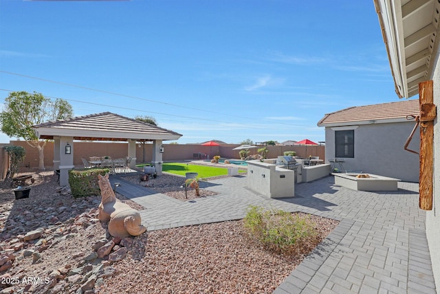 view of yard featuring a patio area, an outdoor fire pit, a fenced backyard, and a gazebo